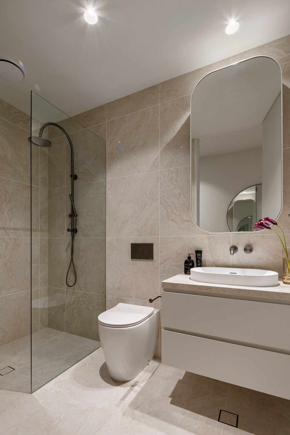 Travertine bathroom with feature mirror